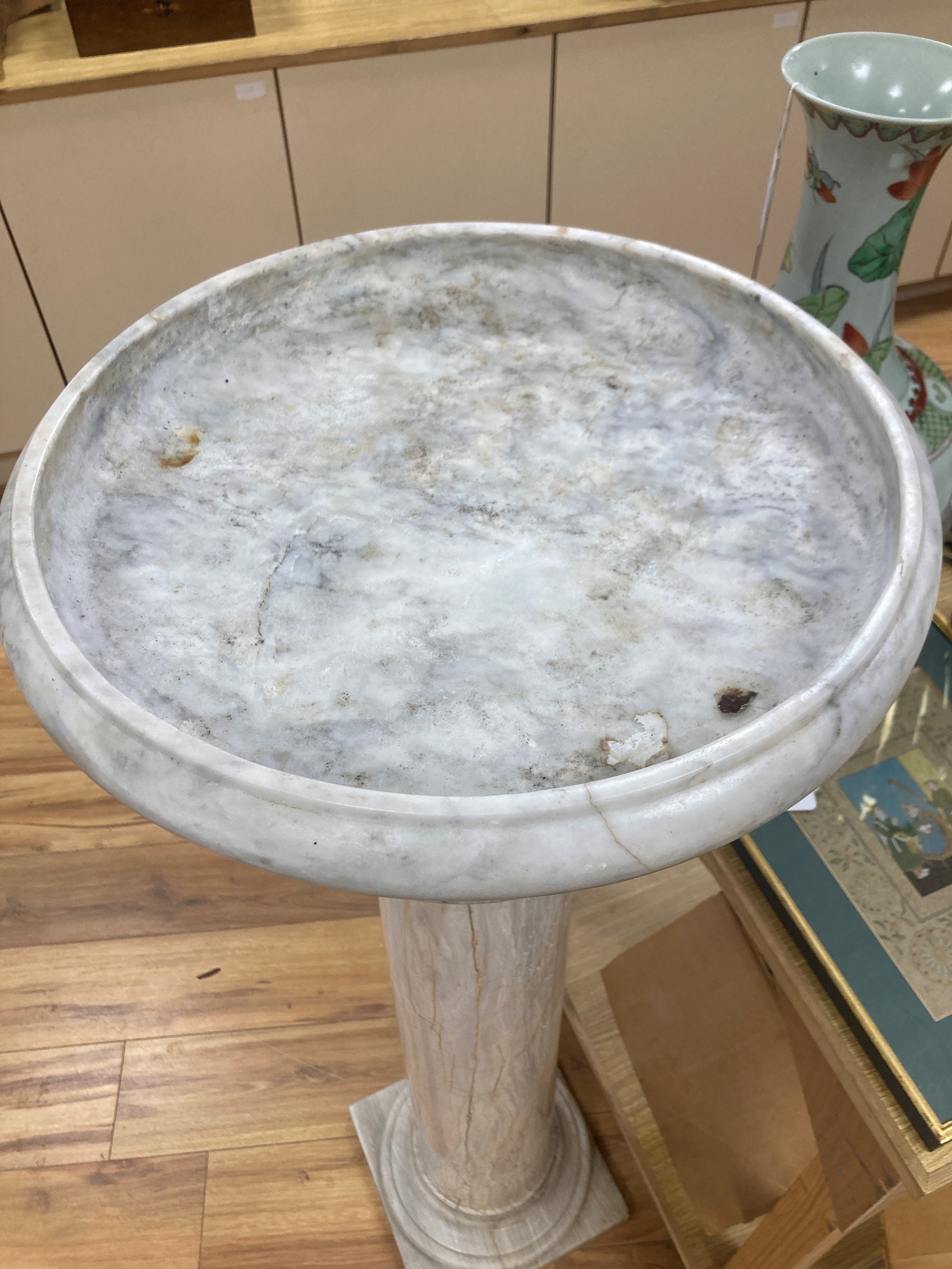 A white marble tazza on associated column stand 120cm high (combined) 43cm diameter (tazza)